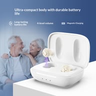 Hearing aids in white charging case with couple in background