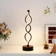 Modern spiral LED desk lamp on clean white desk with brightness control
