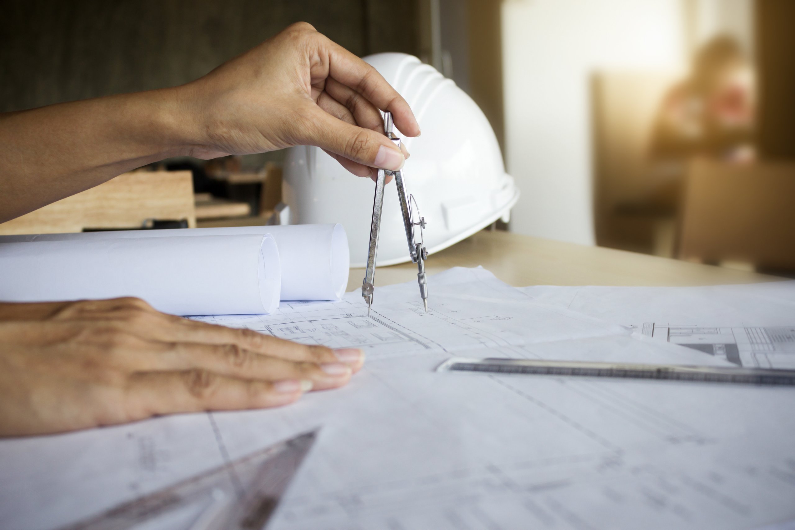 hands engineer working blueprint construction concept engineering tools vintage tone retro filter effect soft focus selective focus 1 scaled