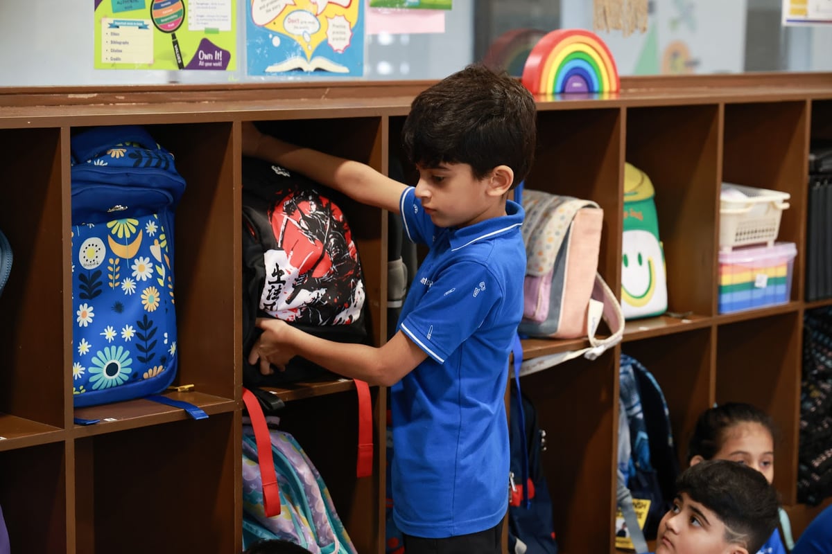 FSM student at the classroom shelves