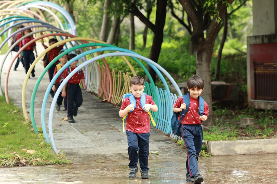 Students walking through the garden arches