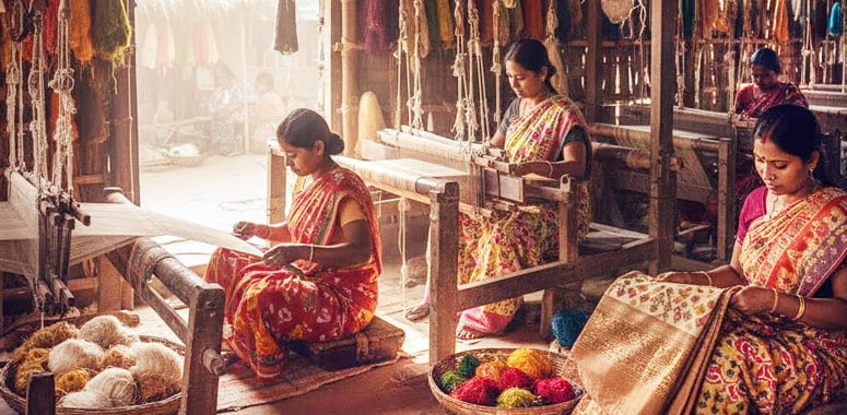 Silk weavers at Sualkuchi looms