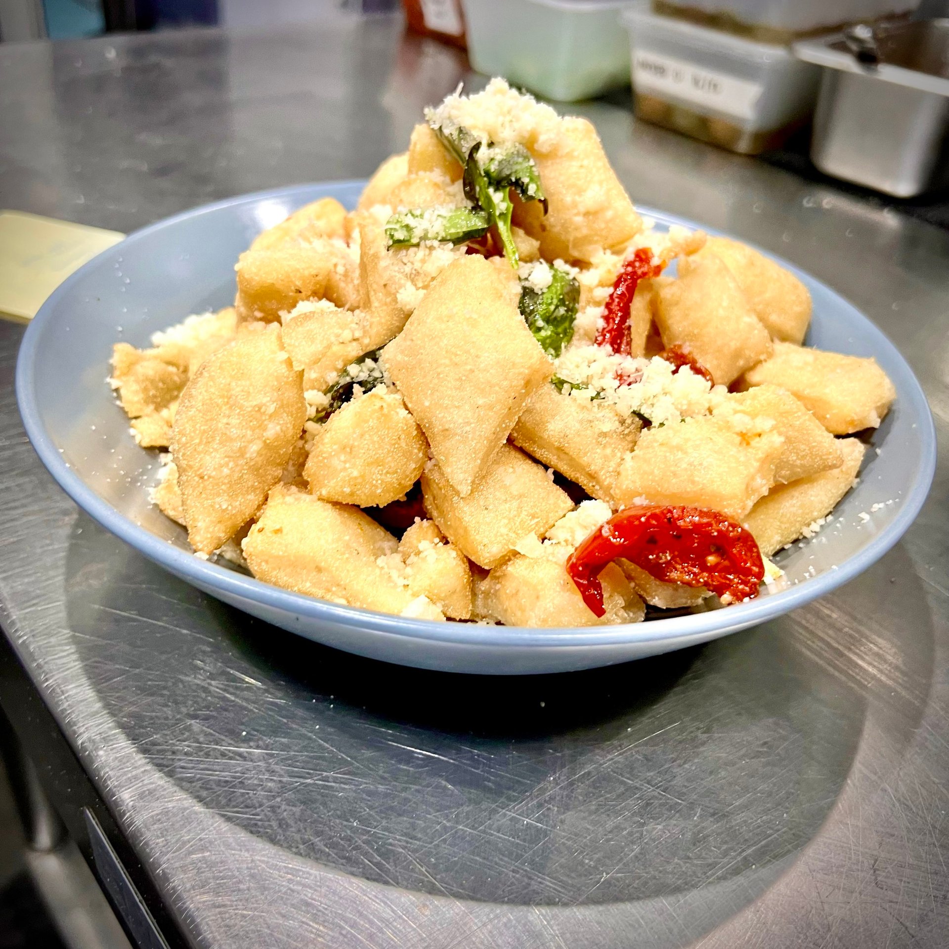 Fried focaccia bites with semi-dried tomato and parmesan