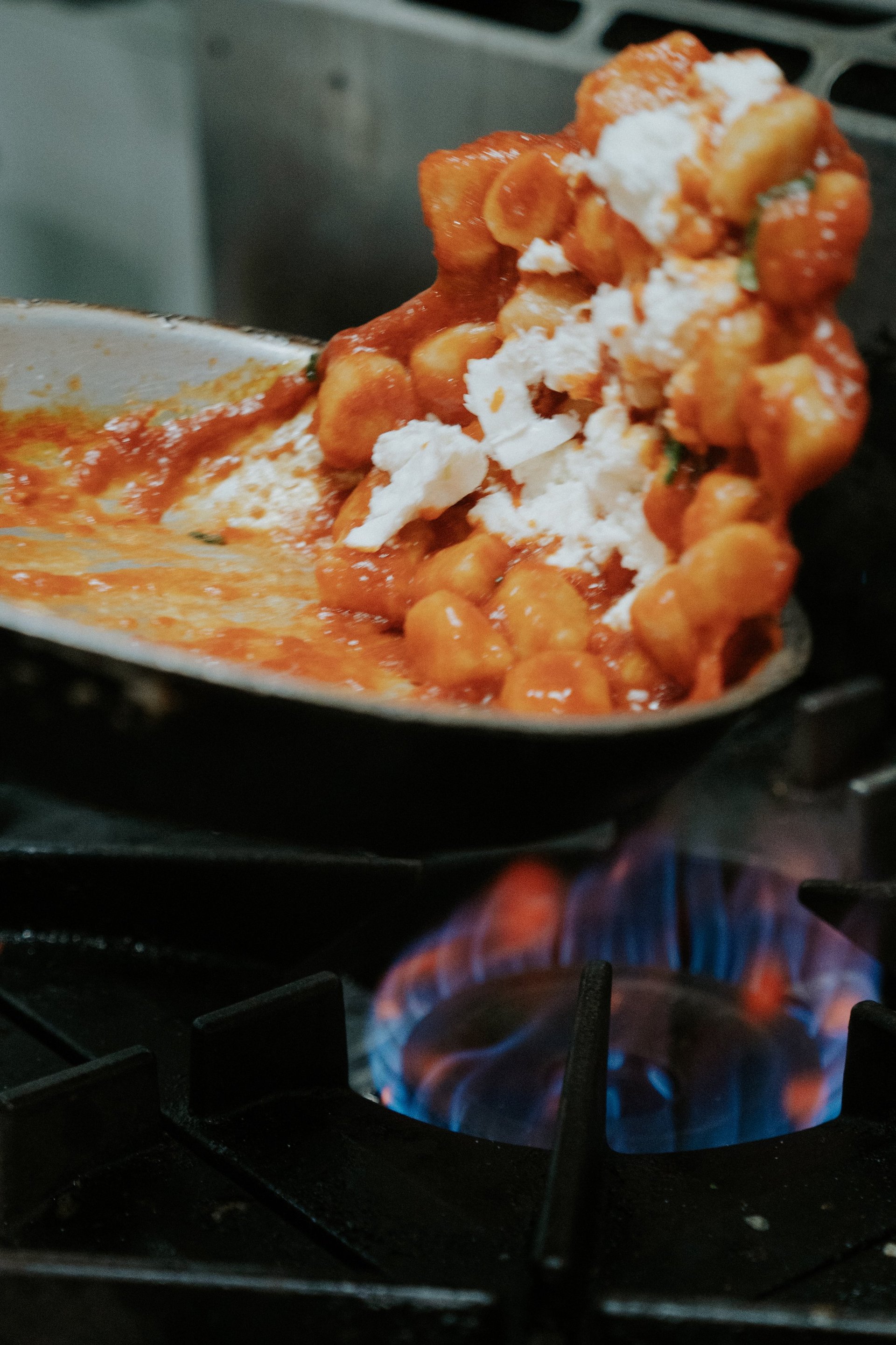 Gnocchi tossed in the pan over the gas flame