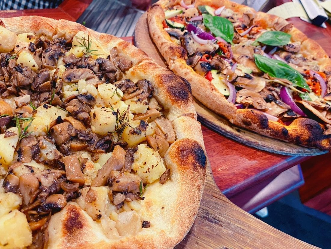 A pizza with potatoes, mushrooms and rosemary