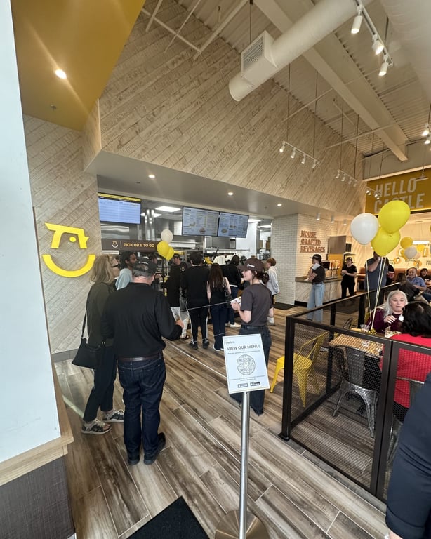 Customers ordering at the counter during Starbird Chicken's soft opening in Castle Rock