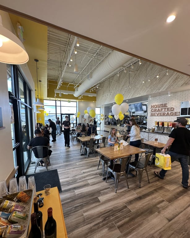 Starbird Chicken dining room with high ceilings and yellow accents
