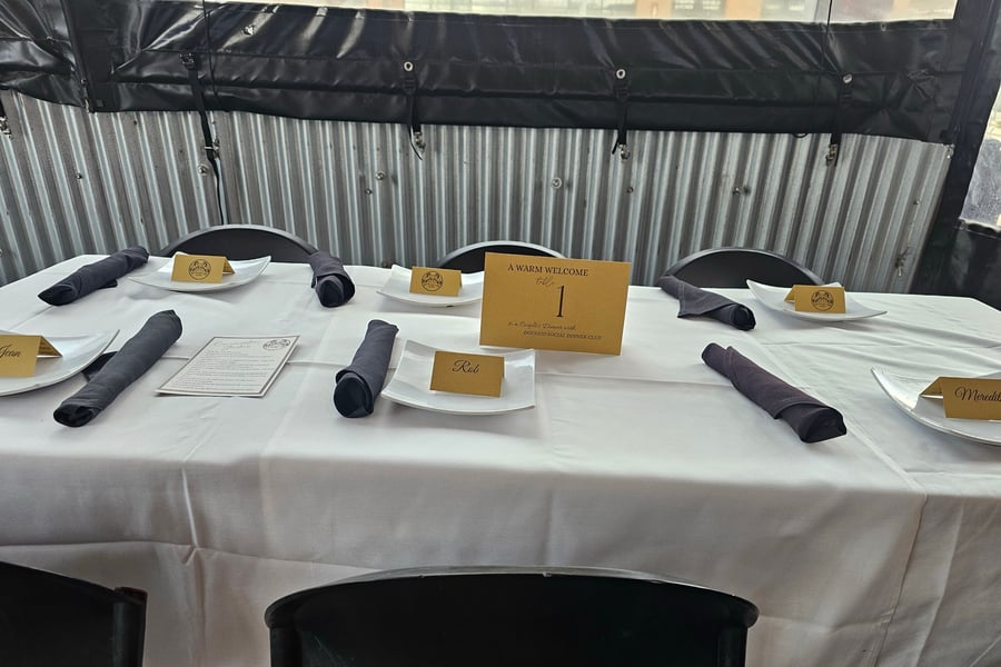 A welcome name card at a DougCo Social Couples Dinner table