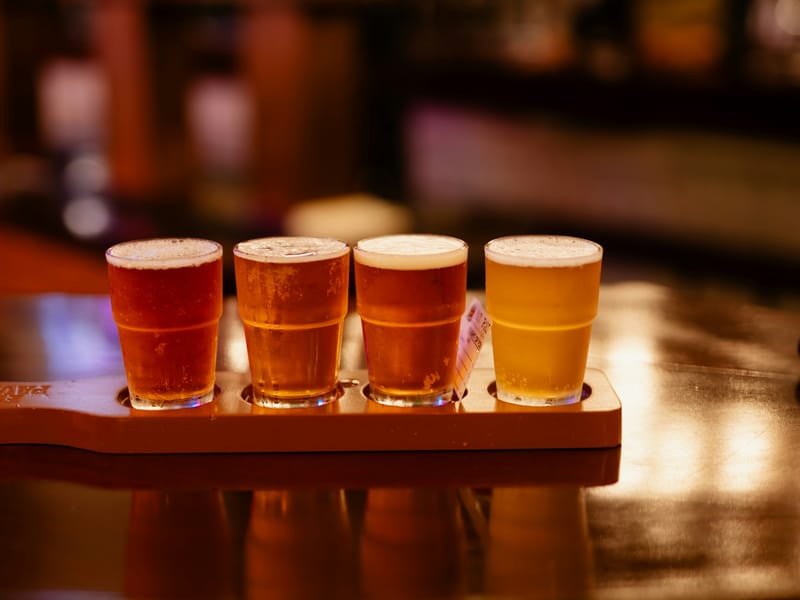 Illustrative image: a flight of beer glasses on a bar