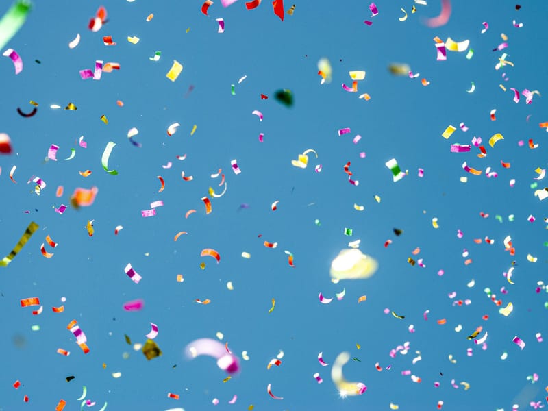 Illustrative image: colorful confetti against a blue sky
