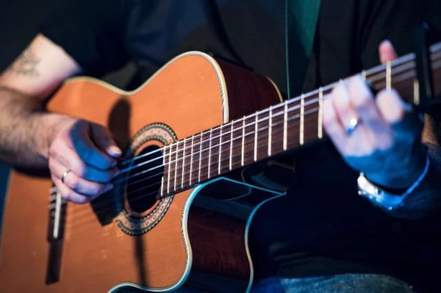 Close-up of an acoustic guitarist performing at The Groove at Lyric