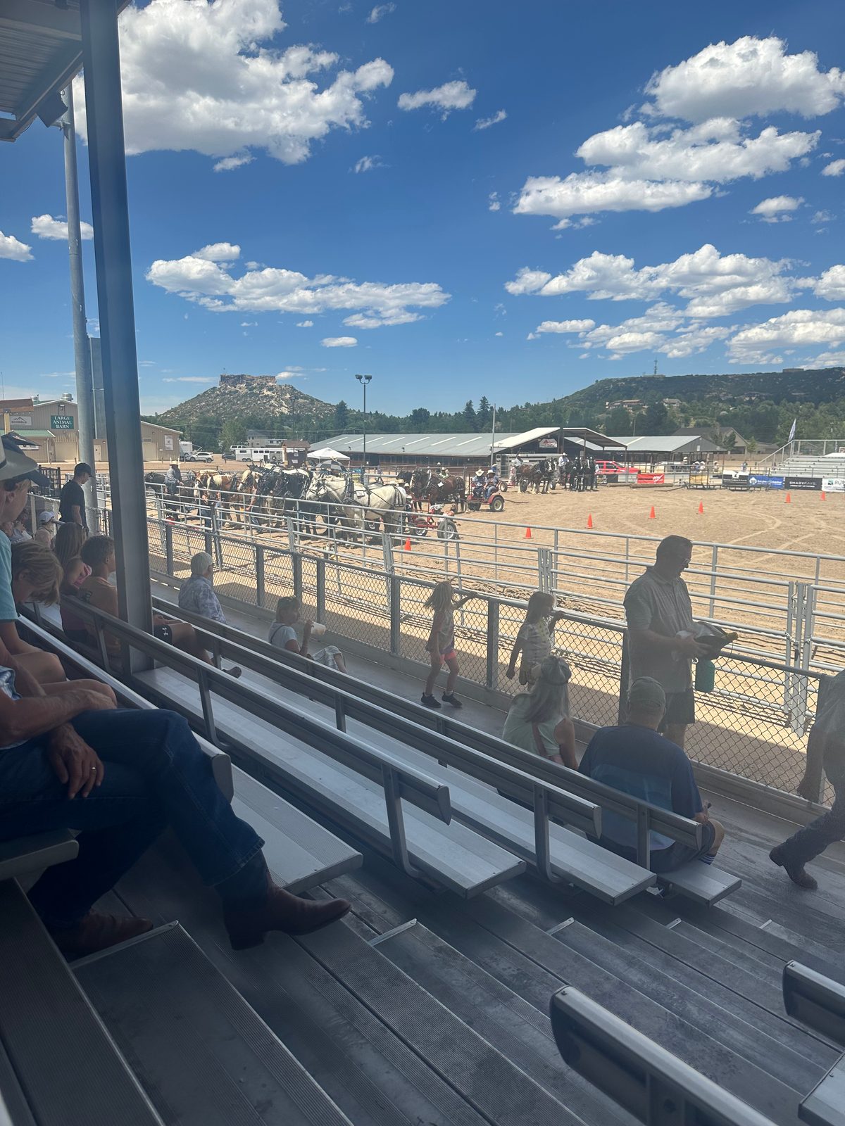 The view from the stands at the Douglas County Fair & Rodeo arena in Castle Rock, with Castle Rock's namesake butte in the background on a sunny day