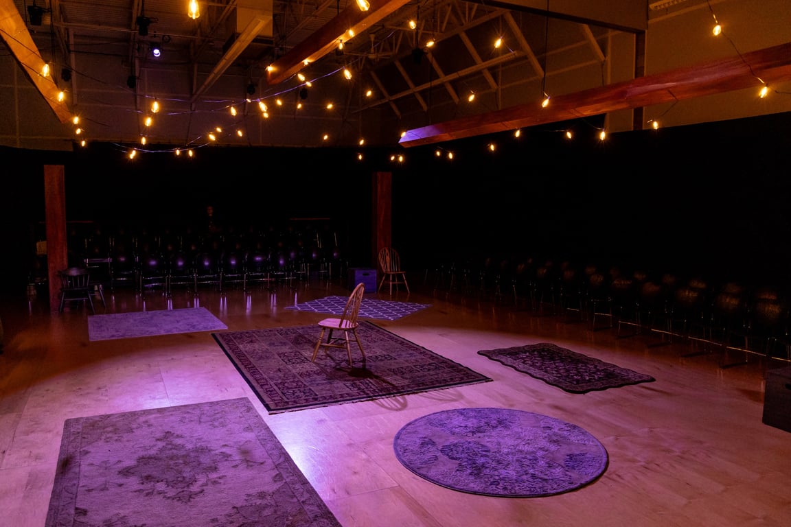 A current PAA studio, set in the round with rugs and string lights for a production of Bright Star. The expansion adds two more studios.