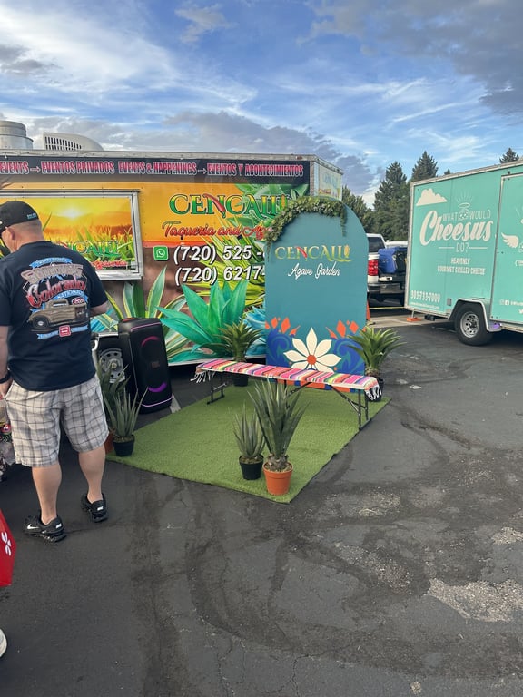 Cencalli Taqueria's truck with its Agave Garden photo op — a serape-covered bench flanked by potted agaves — next to the What Would Cheesus Do? grilled cheese trailer.