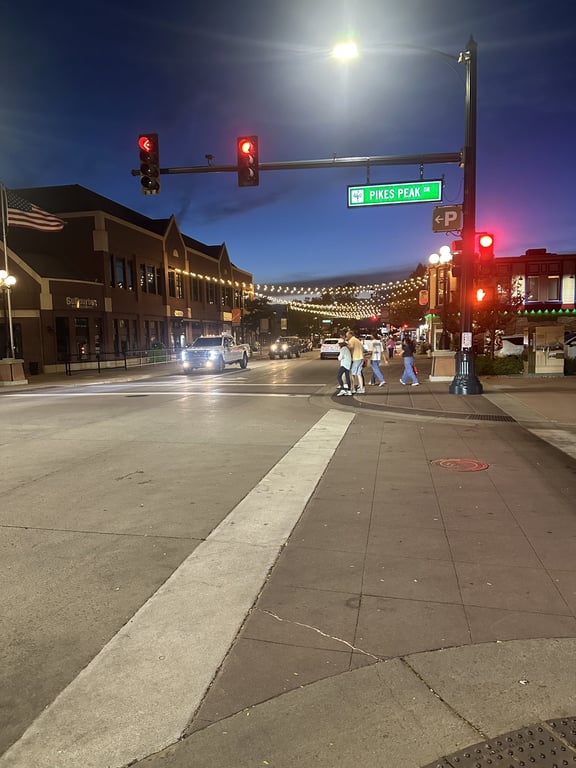 Mainstreet at Pikes Peak Drive after the festival, with downtown Parker's string lights glowing against the last of the dusk.
