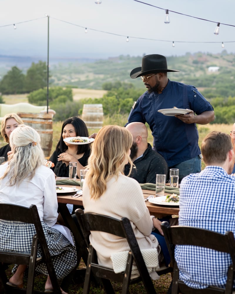 Chef Juwanza serving a course at the Sunset Supper Club at KB Ranch