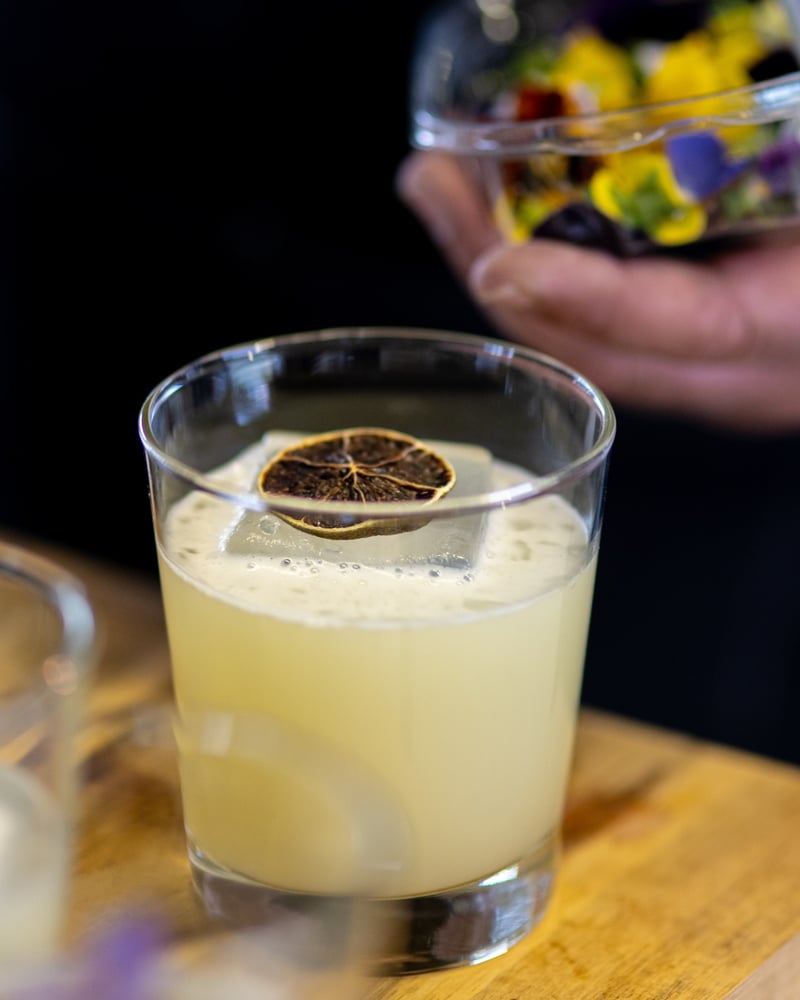 A handcrafted cocktail paired with a course at the Sunset Supper Club