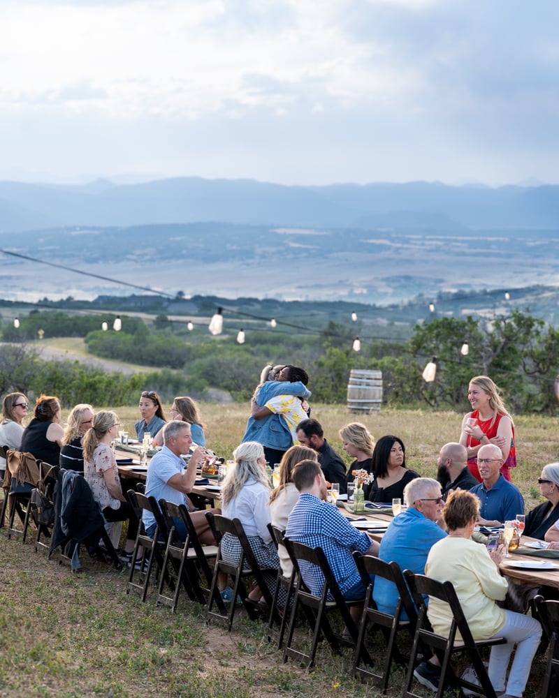 Guests dining together at the communal table at the Sunset Supper Club