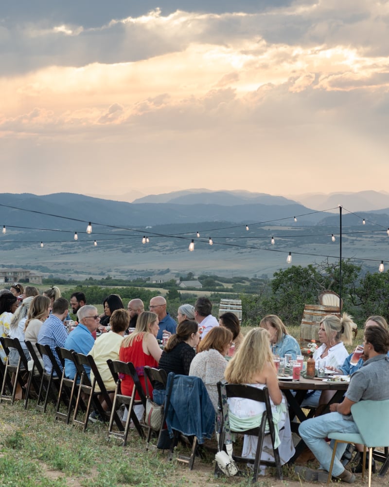 The communal dinner table set at golden hour at the Sunset Supper Club, KB Ranch in Castle Rock
