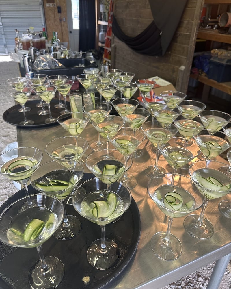 A tray of cucumber cocktails lined up at the bar