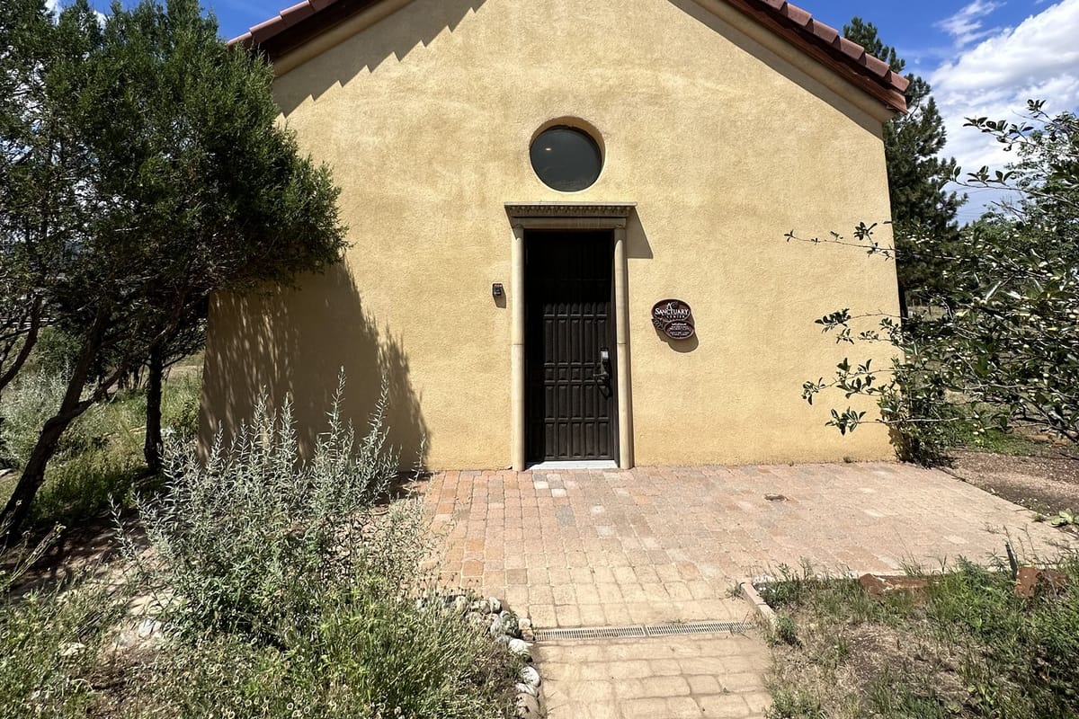 The adobe chapel at A Sanctuary Center with its red tile roof and round window