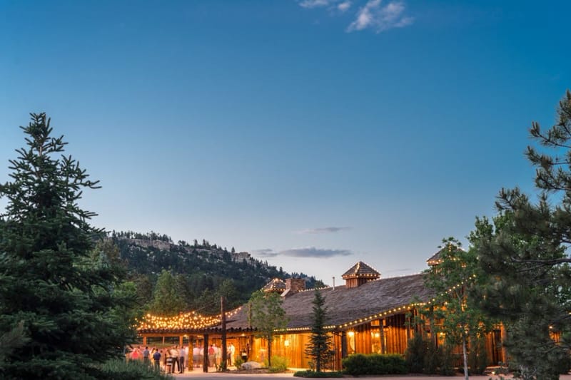 Albert's Lodge lit up at dusk at Spruce Mountain Ranch
