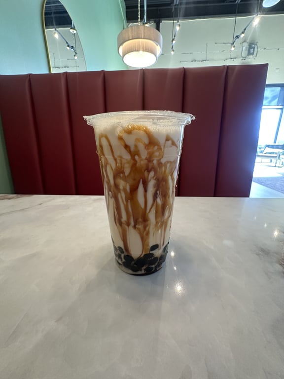 Brown sugar boba milk tea with fresh pearls and caramel drizzle at Badger & Bloom Boba