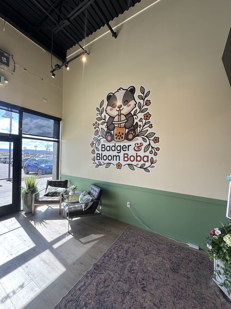The Badger & Bloom Boba mural — a badger holding a boba cup