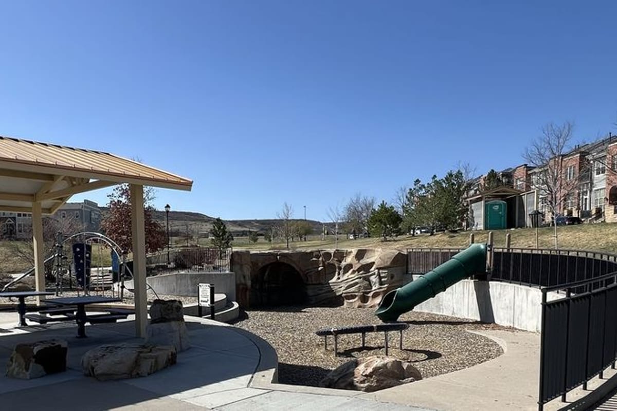 Wide view of Belvedere Park's playground and lawn