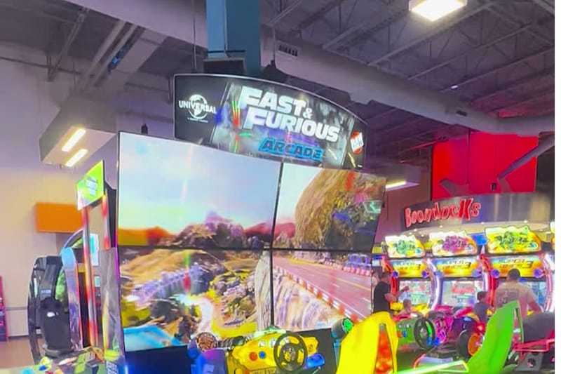 The Fast & Furious arcade racers and neon game cabinets inside Boondocks Food & Fun in Parker