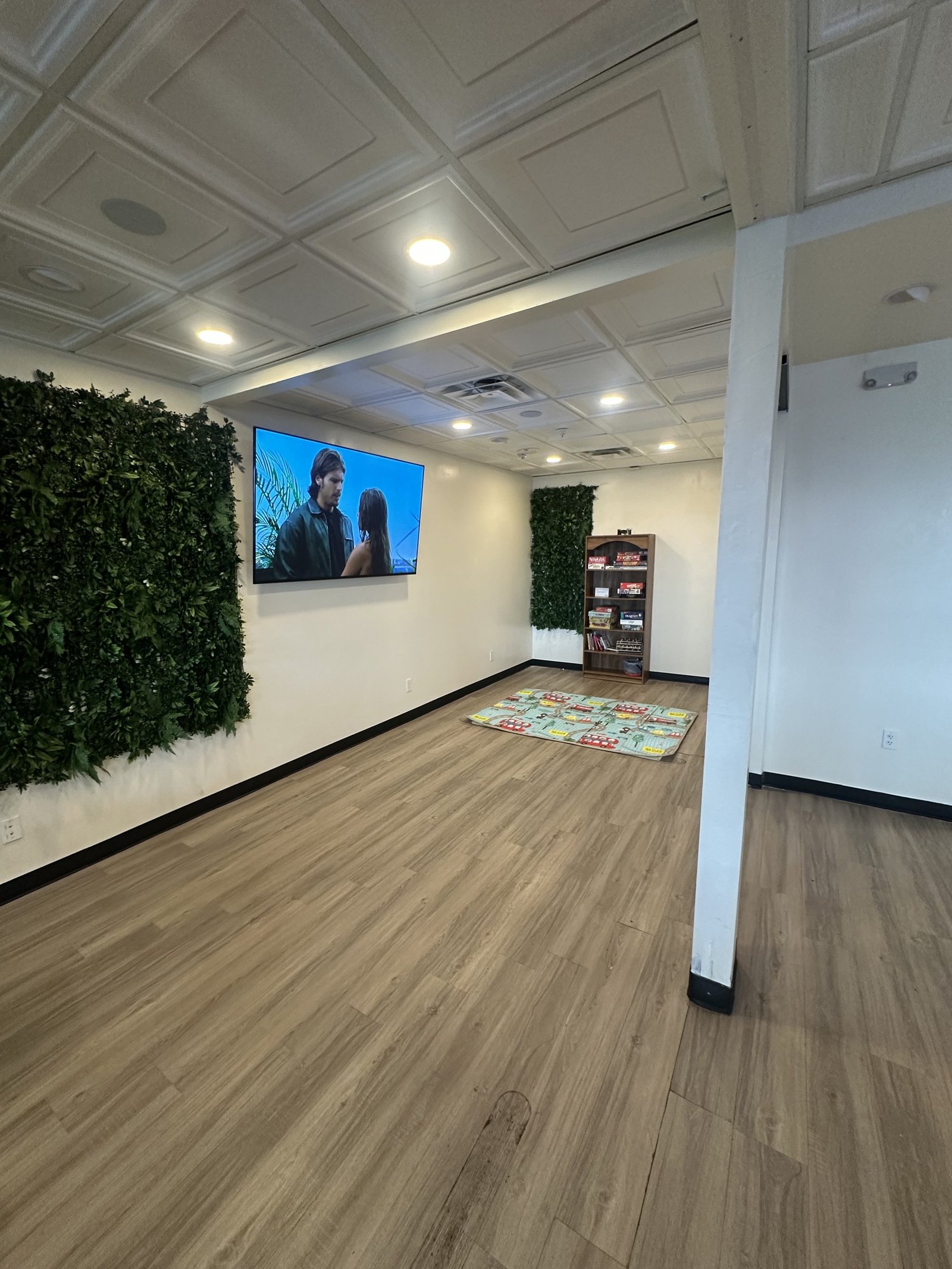 The kids' area with a green wall and play mat at Border Burger Sports Bar
