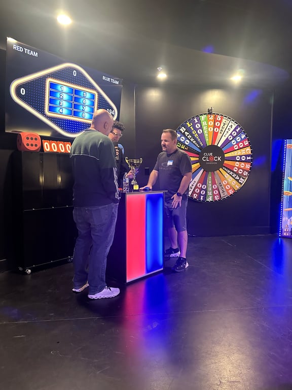 Players at the buzzer podium during Friendly Feud at ClueClock in Castle Pines