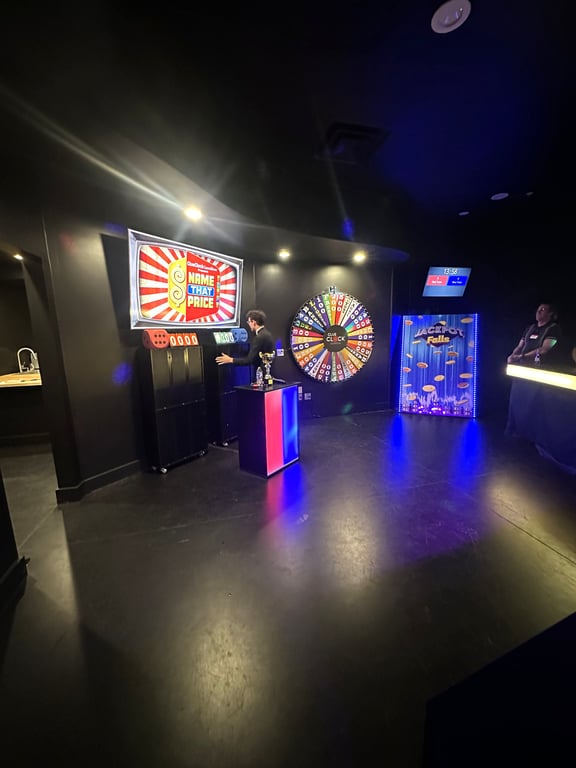 The ClueClock Gameshow stage in Castle Pines with the Name That Price screen, the prize wheel and the Jackpot Falls board