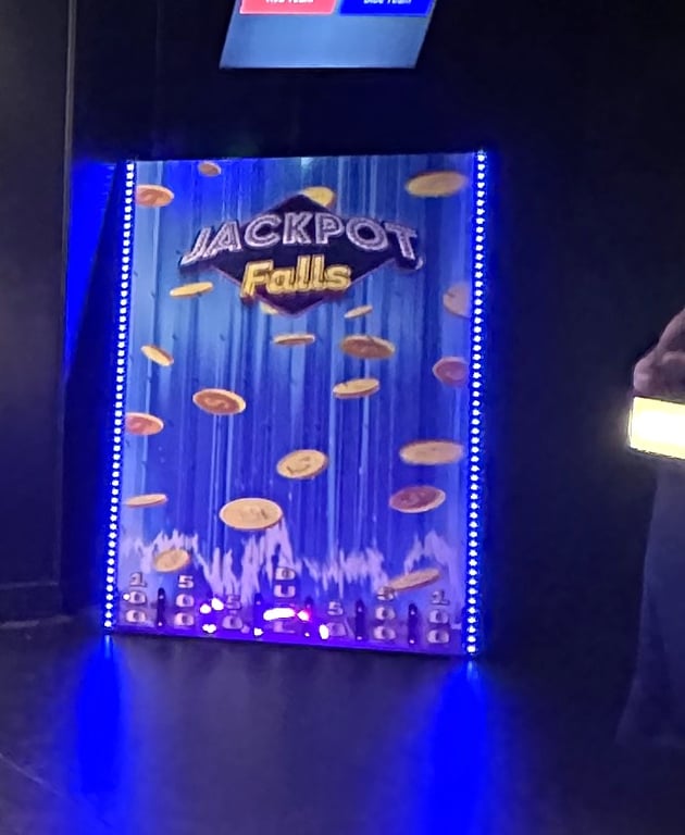 The Jackpot Falls Plinko board lit up in the ClueClock Gameshow room