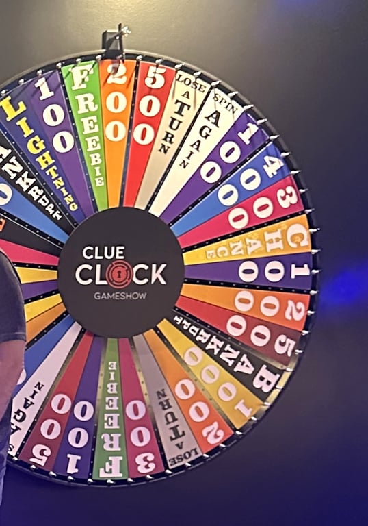 The Spin To Win prize wheel at ClueClock in Castle Pines, with the ClueClock Gameshow logo on the hub