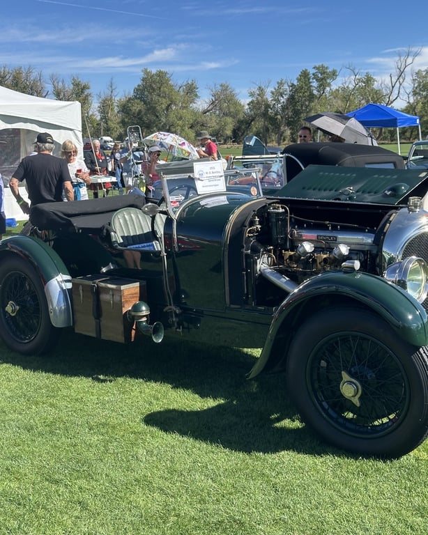 A vintage green open-top British car at the British Car Show at the Colorado Highland Games
