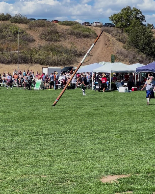 A caber flipping end over end during the heavy athletics at the Colorado Highland Games in Sedalia