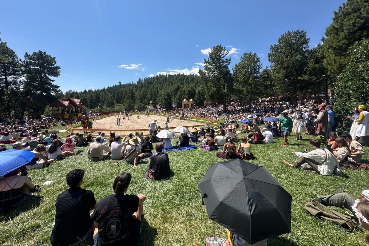 Crowd watching the joust from the hillside seating at the Colorado Renaissance Festival in Larkspur