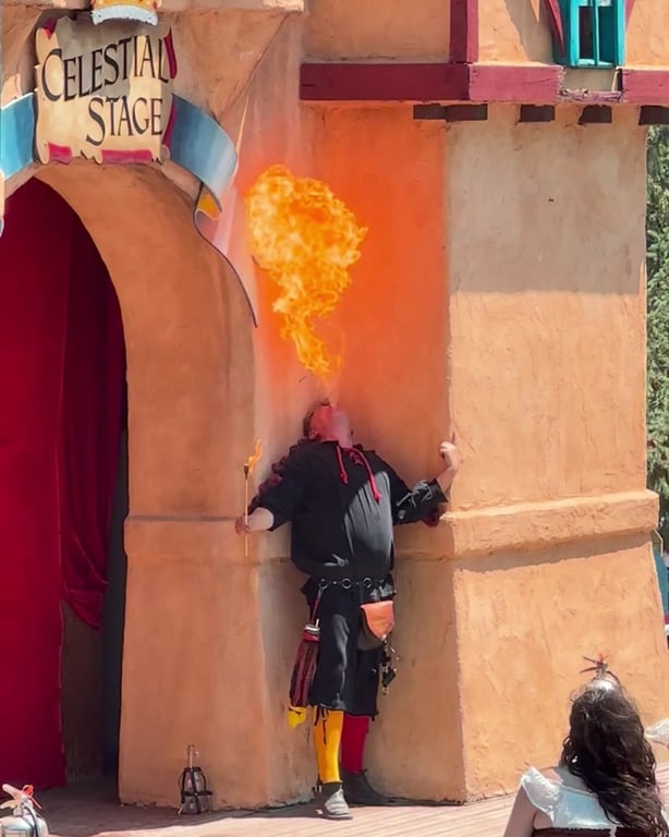 A fire performer breathing a plume of fire at the Celestial Stage of the Colorado Renaissance Festival