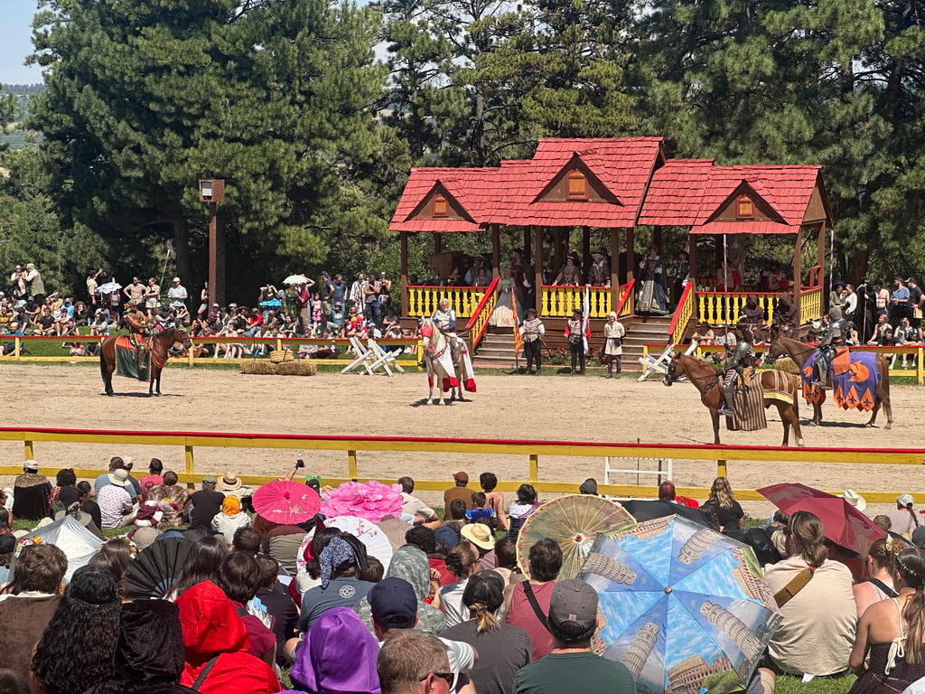Armored knights on horseback in the jousting arena at the Colorado Renaissance Festival