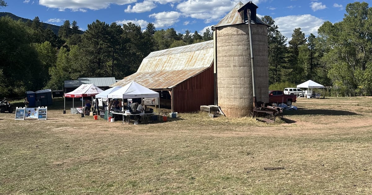 The red barn and stone silo with festival tents at Sandstone Ranch during the Douglas County Fall Festival in Larkspur