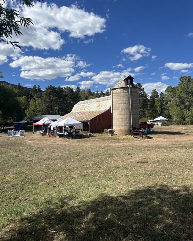 The red barn and stone silo behind the festival tents at Sandstone Ranch