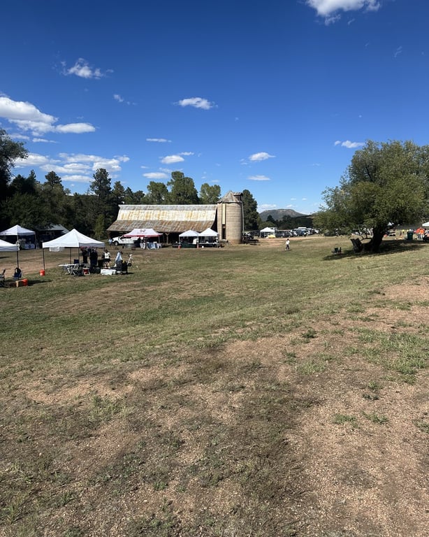 Festival tents set up on the meadow in front of the barn at Sandstone Ranch