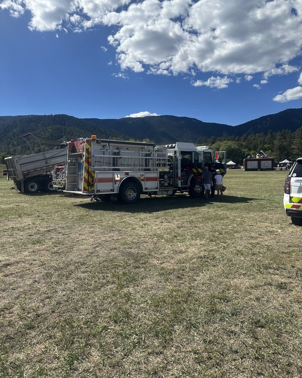 A fire engine parked in the meadow with the foothills behind it at the Douglas County Fall Festival