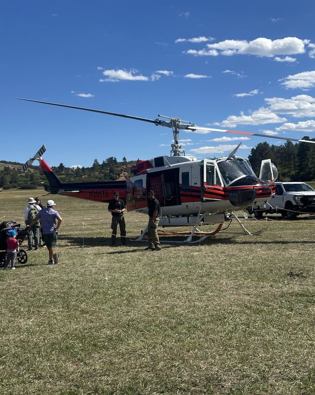 Douglas County's firefighting helicopter parked in the field at the Douglas County Fall Festival