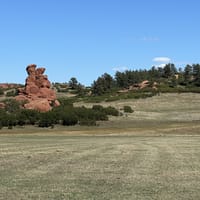Red sandstone rock formations above the meadow at Sandstone Ranch Open Space in Douglas County, Colorado