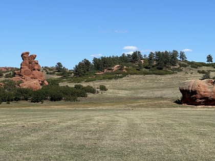 Red sandstone rock formations above the meadow at Sandstone Ranch Open Space in Douglas County, Colorado