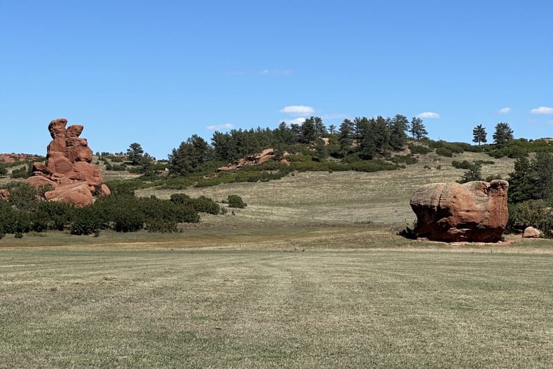 Red sandstone rock formations above the meadow at Sandstone Ranch Open Space in Douglas County, Colorado