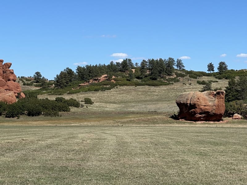 Red sandstone rock formations above the meadow at Sandstone Ranch Open Space in Douglas County, Colorado