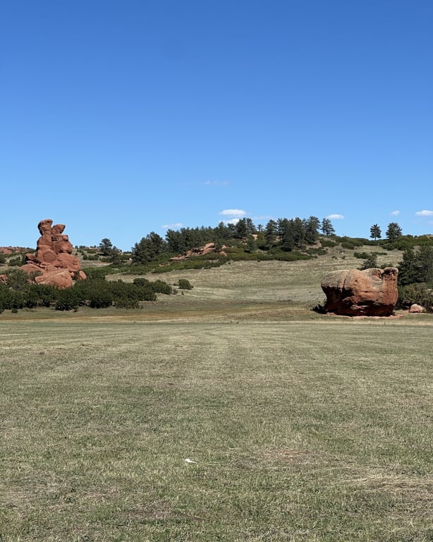 Red sandstone rock formations above the meadow at Sandstone Ranch in Larkspur